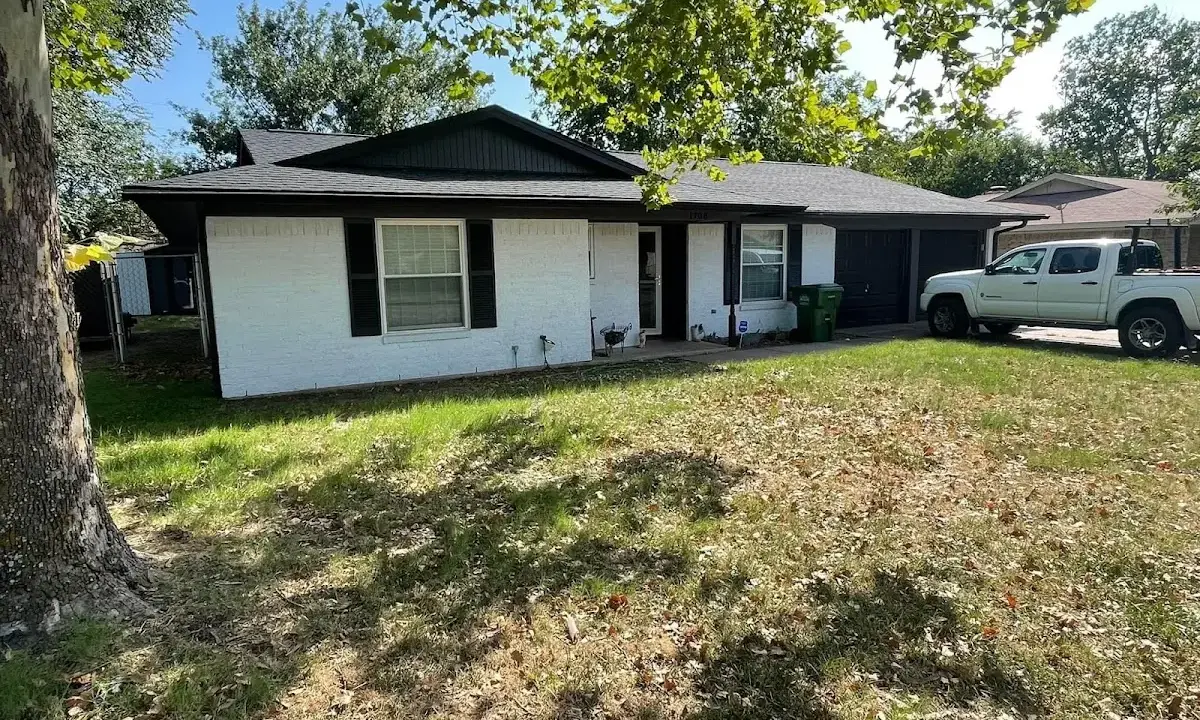Professional roofing crew working on a residential roof in Merrill